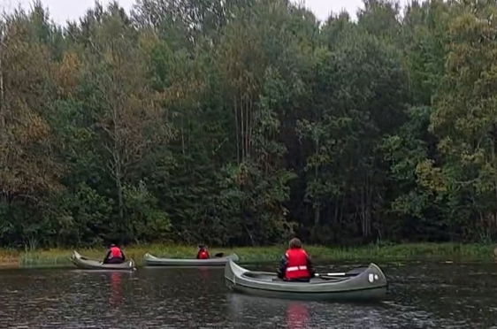 En gruppe mennesker i kanoer på en elv