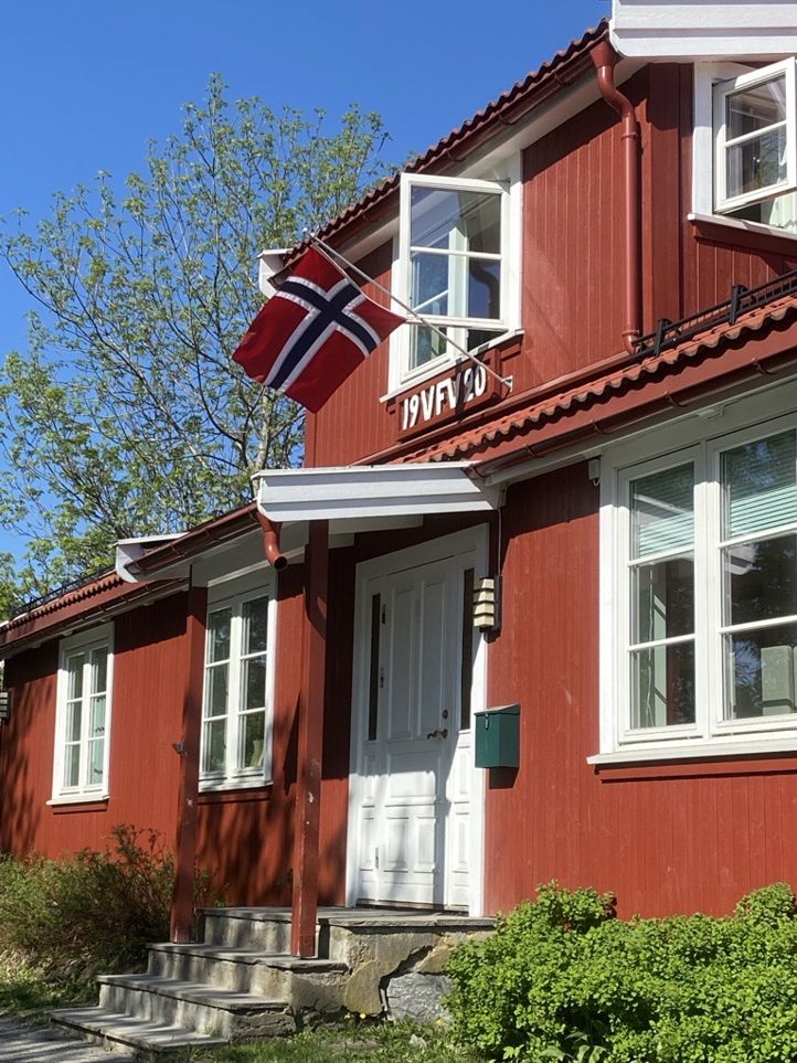 En rød bygning med flagg på taket