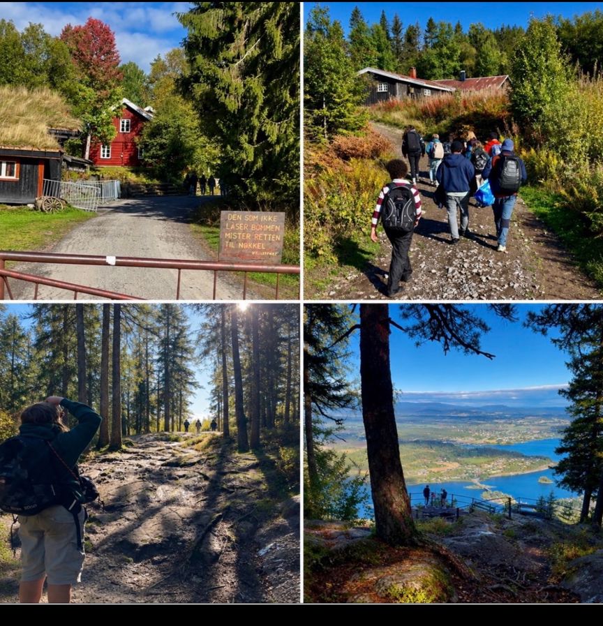 en gruppe mennesker som går på en sti ved siden av en innsjø